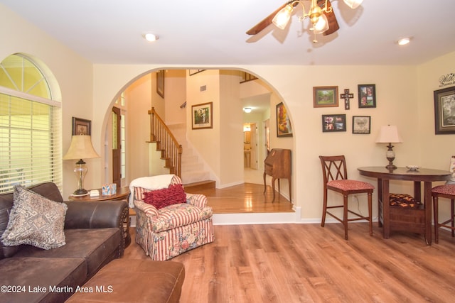 living room featuring wood-type flooring and ceiling fan