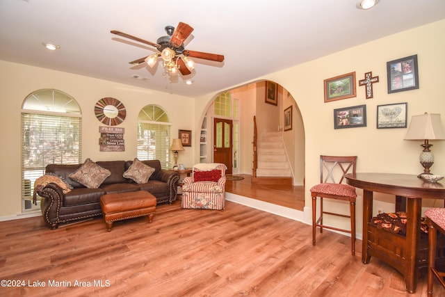 living room featuring plenty of natural light, ceiling fan, and light hardwood / wood-style flooring