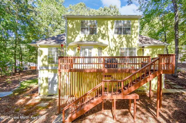 rear view of house featuring a deck