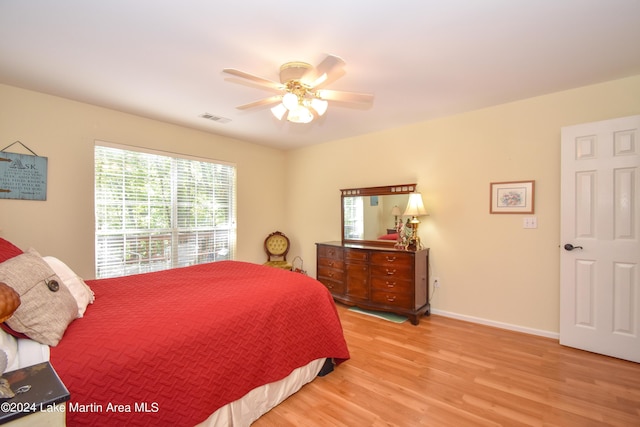 bedroom with light hardwood / wood-style flooring and ceiling fan