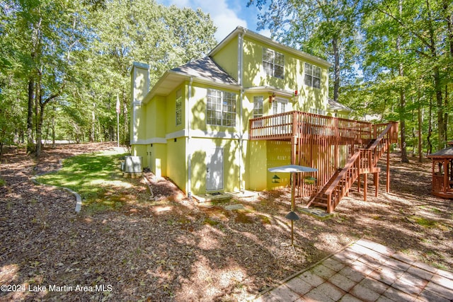 view of property exterior with a deck