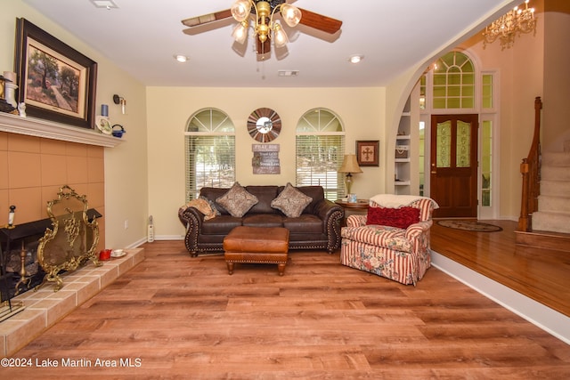 living room featuring ceiling fan and light hardwood / wood-style flooring