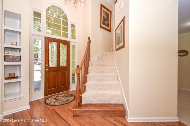 entrance foyer with wood-type flooring and an inviting chandelier