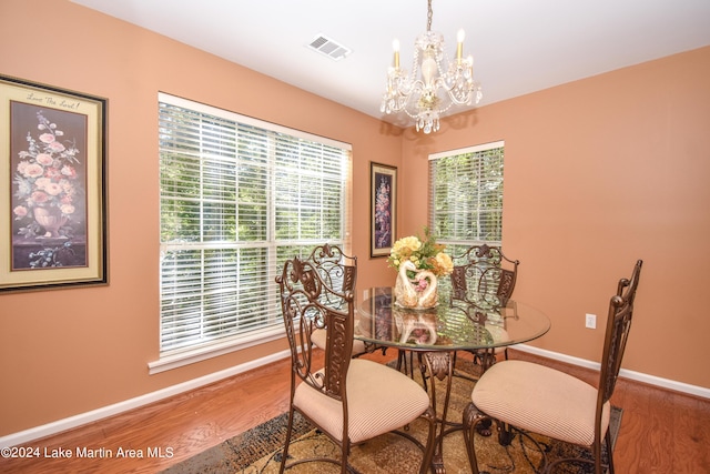 dining area featuring a chandelier, a healthy amount of sunlight, and hardwood / wood-style flooring