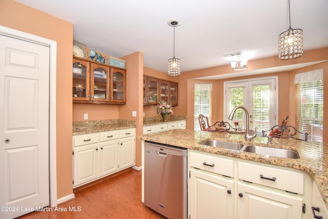 kitchen with dishwasher, light wood-type flooring, sink, and hanging light fixtures