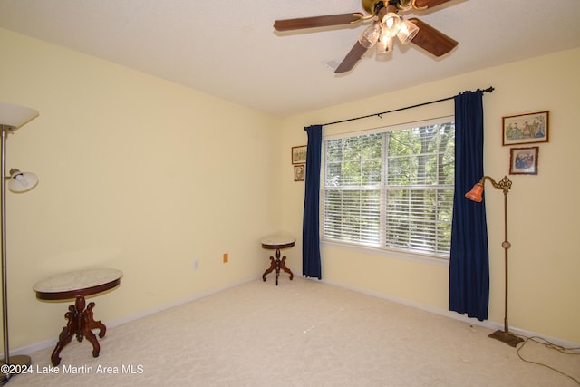 unfurnished room with ceiling fan and carpet floors