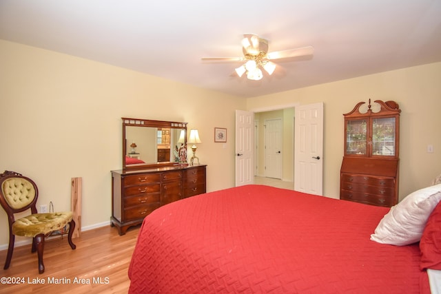 bedroom with ceiling fan and light hardwood / wood-style floors