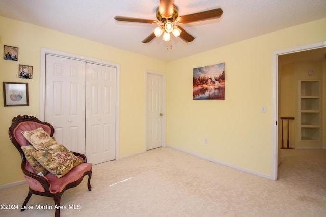 sitting room featuring light carpet and ceiling fan