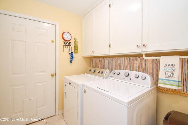 laundry area featuring light tile patterned floors, cabinets, and independent washer and dryer