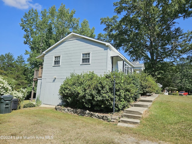 view of side of home featuring a yard