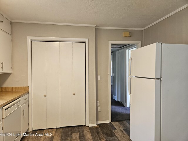 kitchen featuring dark hardwood / wood-style flooring, white appliances, a textured ceiling, crown molding, and white cabinetry