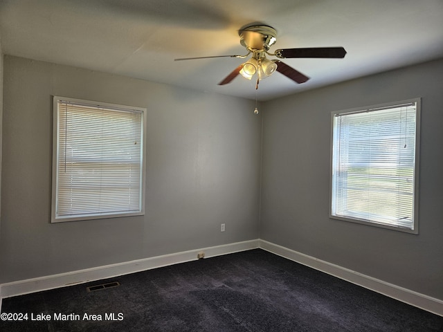 carpeted spare room featuring ceiling fan