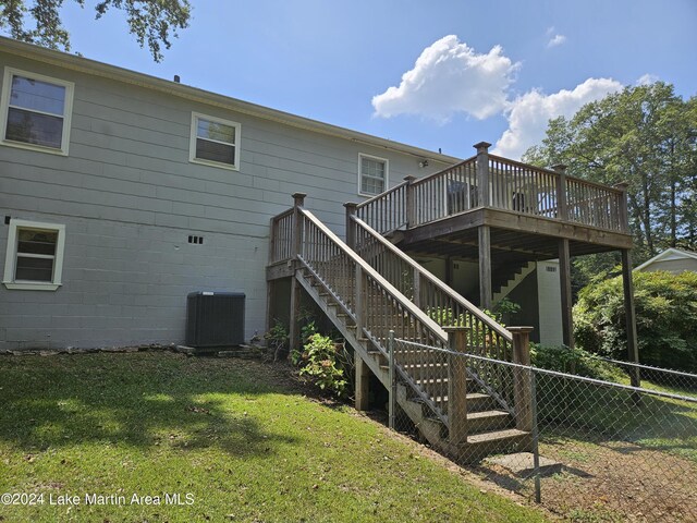 back of house with a lawn, a deck, and central air condition unit