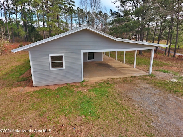 view of property exterior featuring a carport and a lawn