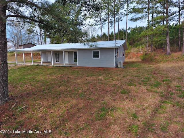 rear view of property with a lawn