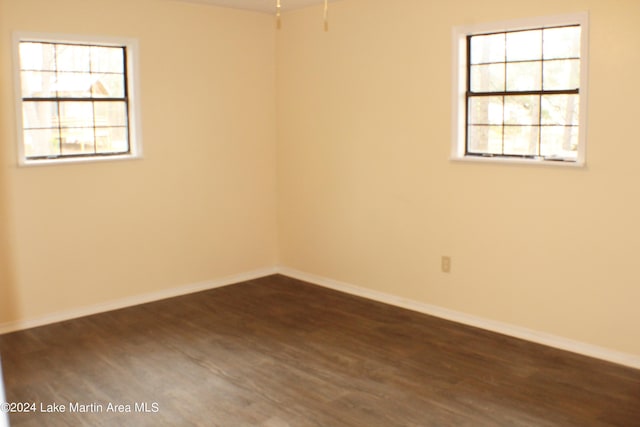 unfurnished room with dark hardwood / wood-style floors