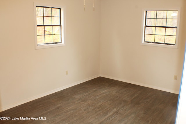 spare room featuring dark hardwood / wood-style flooring