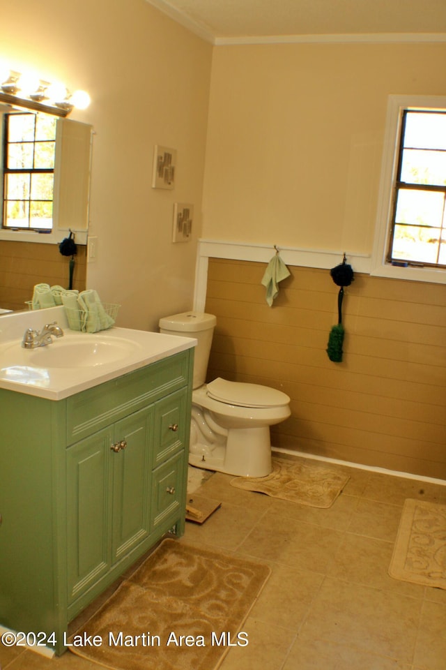 bathroom with toilet, vanity, tile patterned floors, and crown molding