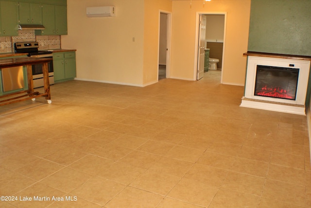 unfurnished living room with light tile patterned floors and a wall mounted AC