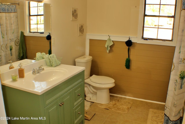 bathroom featuring tile patterned flooring, vanity, and toilet