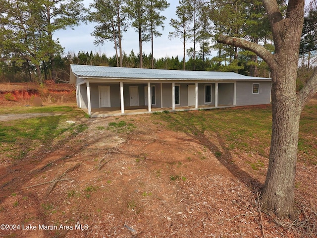 ranch-style house with a porch and a front lawn