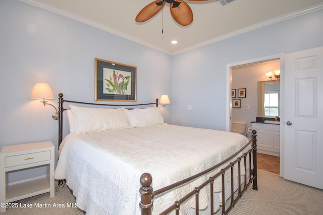 bedroom with ornamental molding, light colored carpet, and connected bathroom