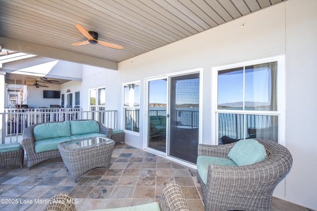 sunroom featuring wood ceiling, vaulted ceiling, and a ceiling fan