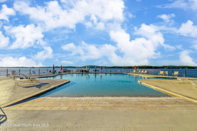 community pool featuring fence and a patio