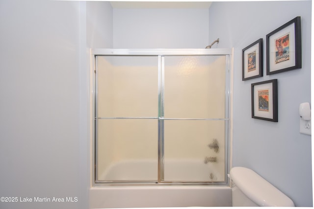 full bathroom with shower / bath combination with glass door and toilet