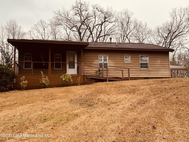 rear view of property with a yard