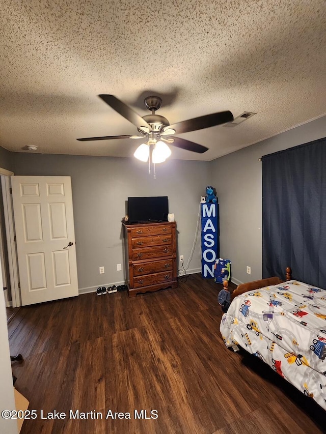 bedroom featuring ceiling fan, a textured ceiling, and dark hardwood / wood-style flooring