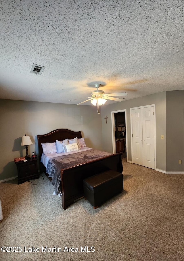 bedroom featuring ceiling fan, carpet flooring, and a textured ceiling