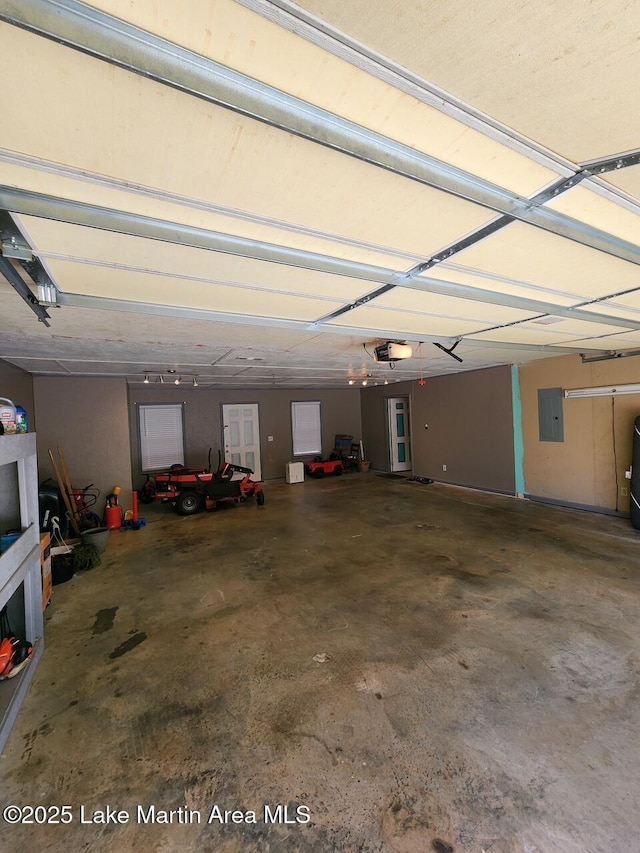 garage featuring a garage door opener and electric panel