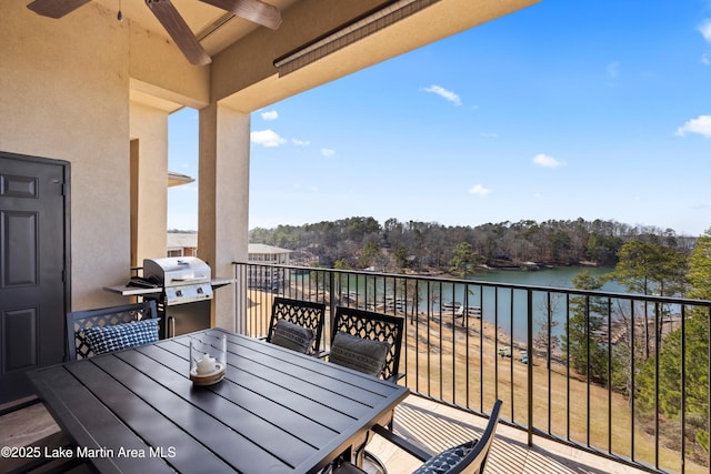 balcony with a water view, area for grilling, and ceiling fan