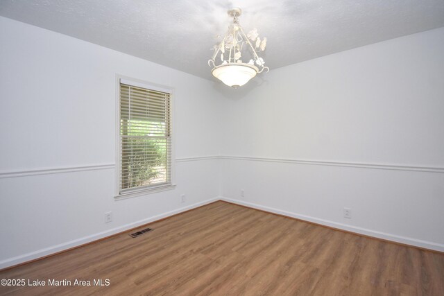 485 Ridgeview Dr, Alexander City, AL 35010 - empty room featuring wood finished floors and a chandelier