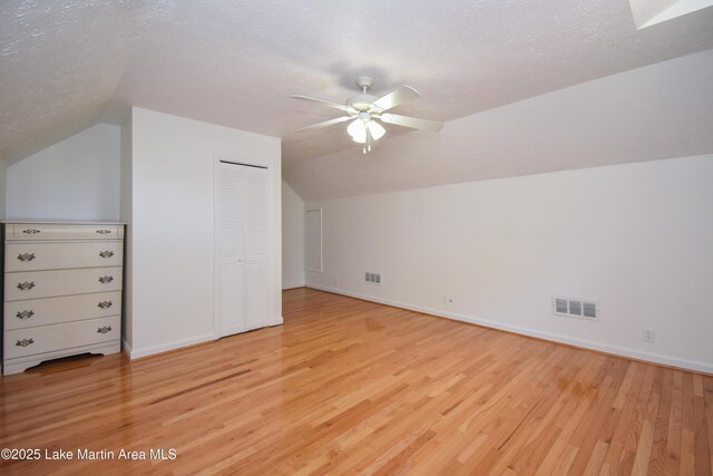 485 Ridgeview Dr, Alexander City, AL 35010 - additional living space with lofted ceiling, light wood-type flooring, ceiling fan, and a textured ceiling