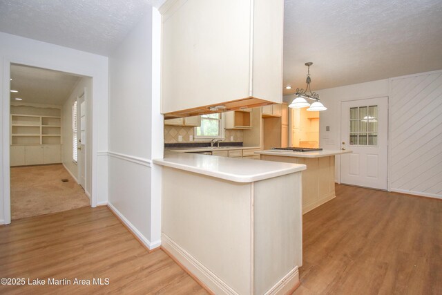 485 Ridgeview Dr, Alexander City, AL 35010 - kitchen with light wood-type flooring, light countertops, backsplash, a kitchen island, and a peninsula