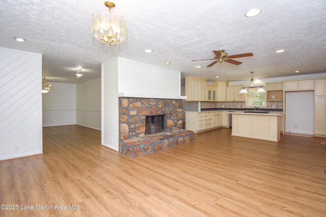 485 Ridgeview Dr, Alexander City, AL 35010 - unfurnished living room featuring light wood-style floors, ceiling fan, recessed lighting, a textured ceiling, and a fireplace