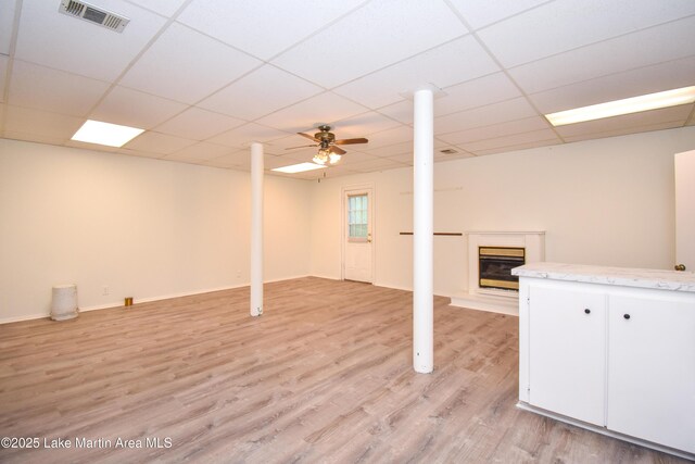 485 Ridgeview Dr, Alexander City, AL 35010 - basement featuring a glass covered fireplace, light wood-style floors, and a paneled ceiling