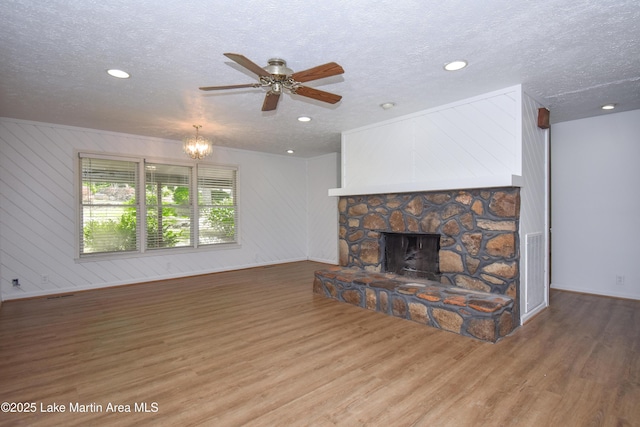 485 Ridgeview Dr, Alexander City, AL 35010 - unfurnished living room featuring wood finished floors, a textured ceiling, a fireplace, a ceiling fan, and recessed lighting