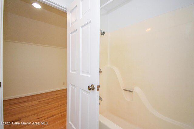 485 Ridgeview Dr, Alexander City, AL 35010 - bathroom featuring wood finished floors and washtub / shower combination