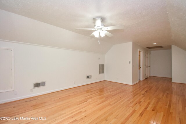 485 Ridgeview Dr, Alexander City, AL 35010 - additional living space featuring lofted ceiling, wood-type flooring, a ceiling fan, and a textured ceiling