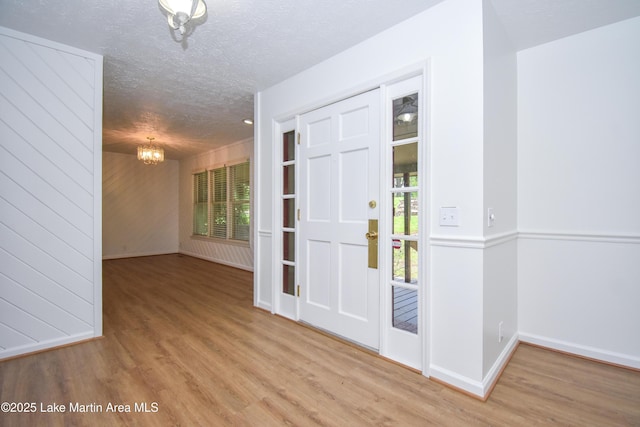 485 Ridgeview Dr, Alexander City, AL 35010 - foyer with a chandelier, wood finished floors, and a textured ceiling