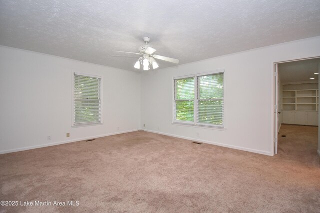 485 Ridgeview Dr, Alexander City, AL 35010 - unfurnished bedroom featuring light carpet, a textured ceiling, ceiling fan, and a walk in closet