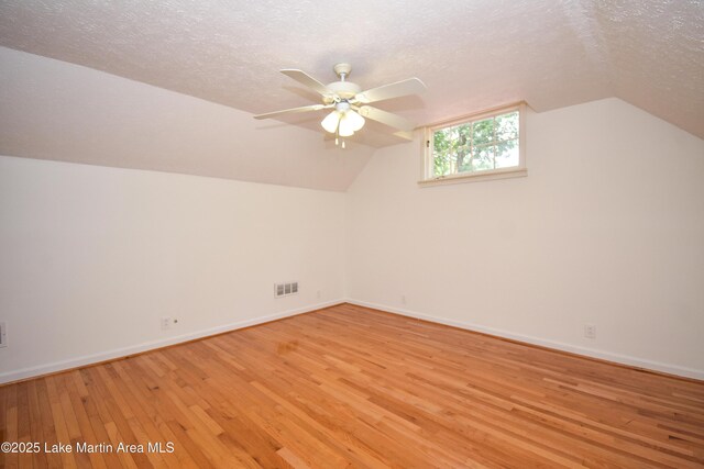 485 Ridgeview Dr, Alexander City, AL 35010 - bonus room with light wood finished floors, a ceiling fan, a textured ceiling, and vaulted ceiling