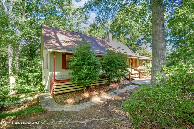 485 Ridgeview Dr, Alexander City, AL 35010 - view of front of house featuring a chimney, a shingled roof, and a wooden deck