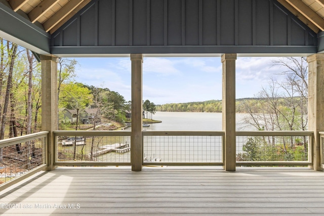 wooden terrace featuring a water view