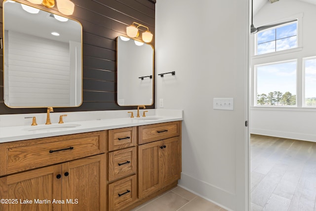 bathroom with a wealth of natural light, double vanity, and a sink