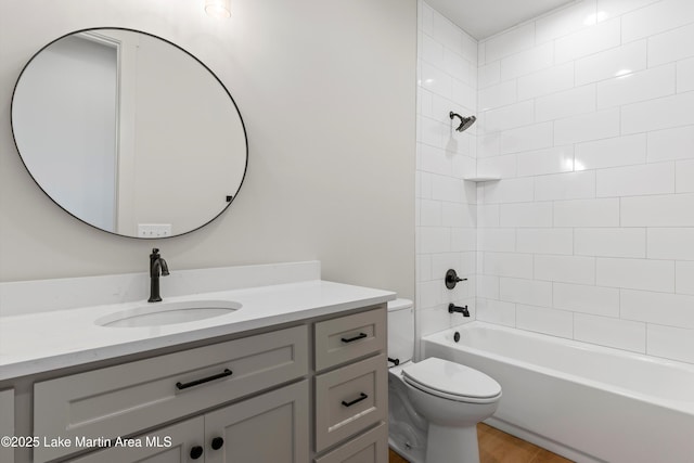 full bath featuring toilet, vanity, shower / bath combination, and wood finished floors