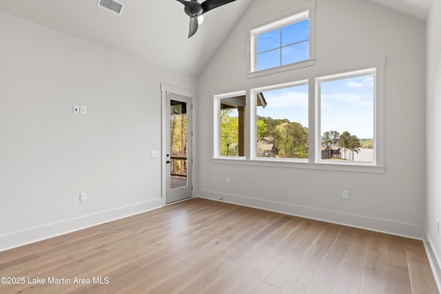 unfurnished room featuring light wood-type flooring, a ceiling fan, a healthy amount of sunlight, and visible vents